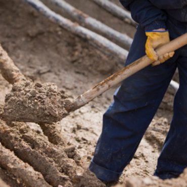 man shovelling dirt