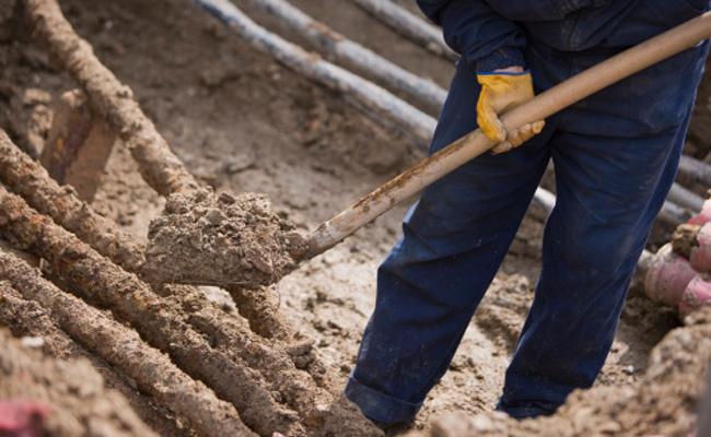 man shovelling dirt