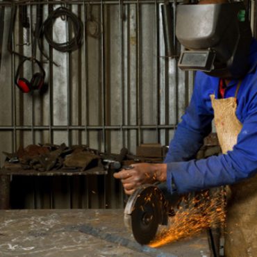 Welder working with machine