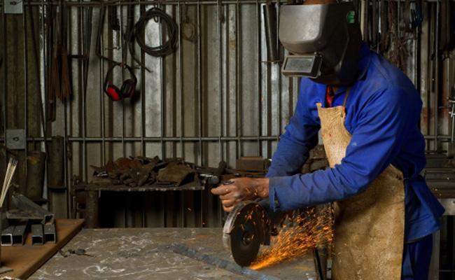 Welder working with machine