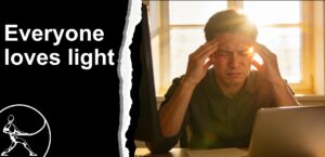 computer worker with back to window, suffering from a headache