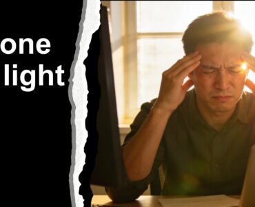 computer worker with back to window, suffering from a headache