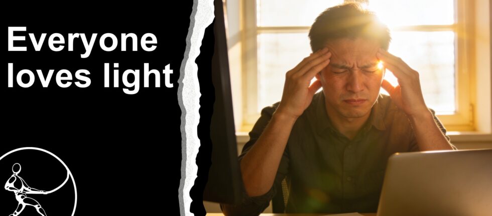 computer worker with back to window, suffering from a headache